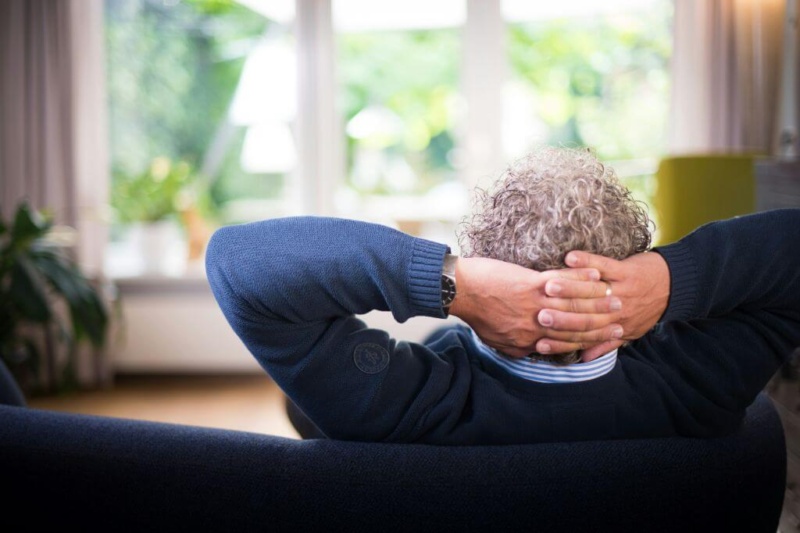 Man attracting money from his couch