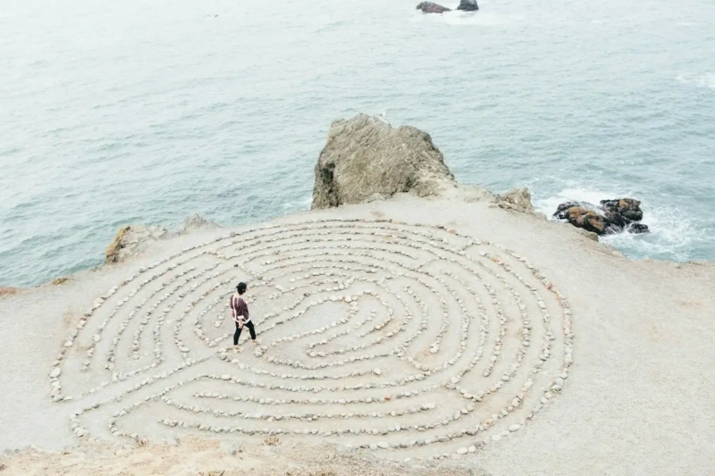 Woman walking working on healing inner wounds by walking in a stone maze